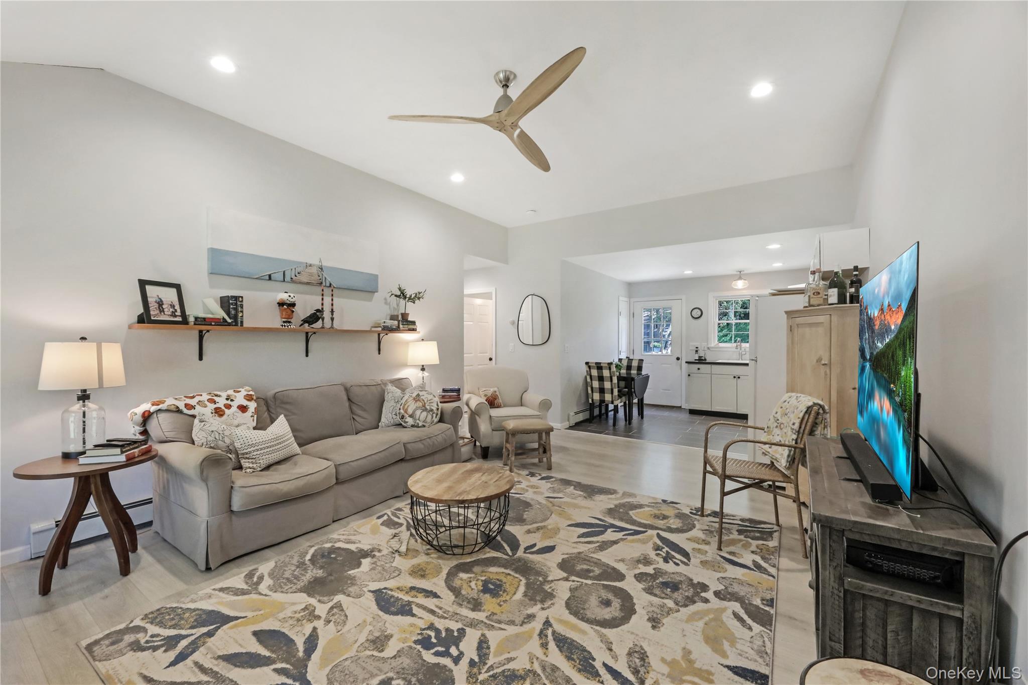 48 Nidzyn Avenue Remsenburg, NY 11960 - Photo 21 of 43 a living room with furniture and a flat screen tv