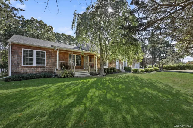 a view of an house with backyard space and garden