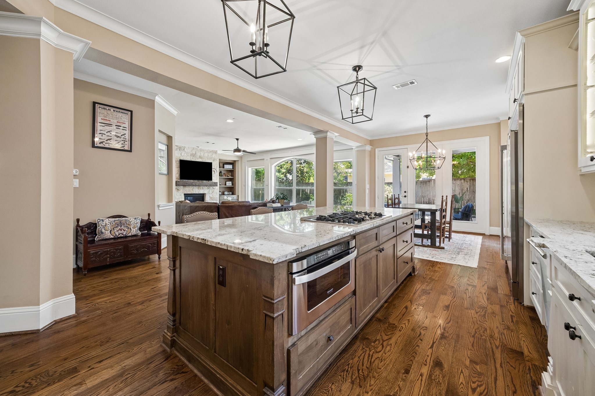 1360 Chippendale Road Houston, TX 77018 - Photo 10 of 34 Another view of the chef's kitchen showcasing the expansive island, extensive granite countertops, and effortless connection to the family room and breakfast room. Thoughtfully designed layout allows for easy entertaining while keeping family and guests connected.