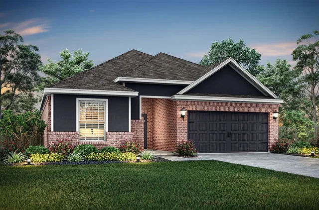 a front view of a house with a garden and yard