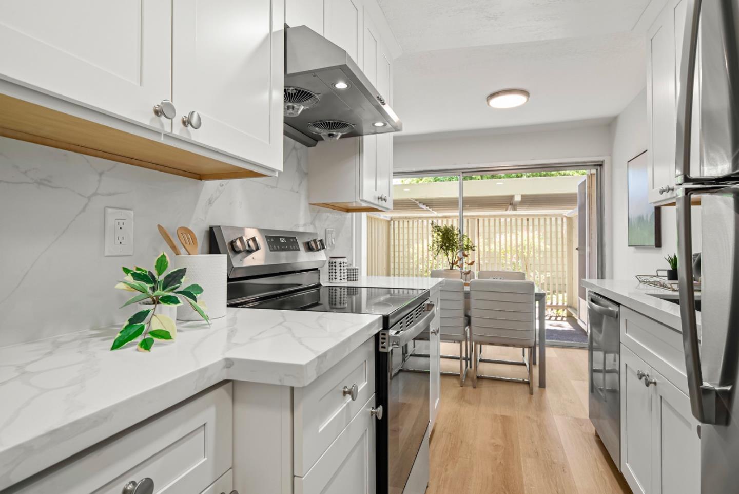 280 Easy Street, Unit 311 Mountain View, CA 94043 - Photo 11 of 29 a kitchen with stainless steel appliances a counter top space cabinets and wooden floor