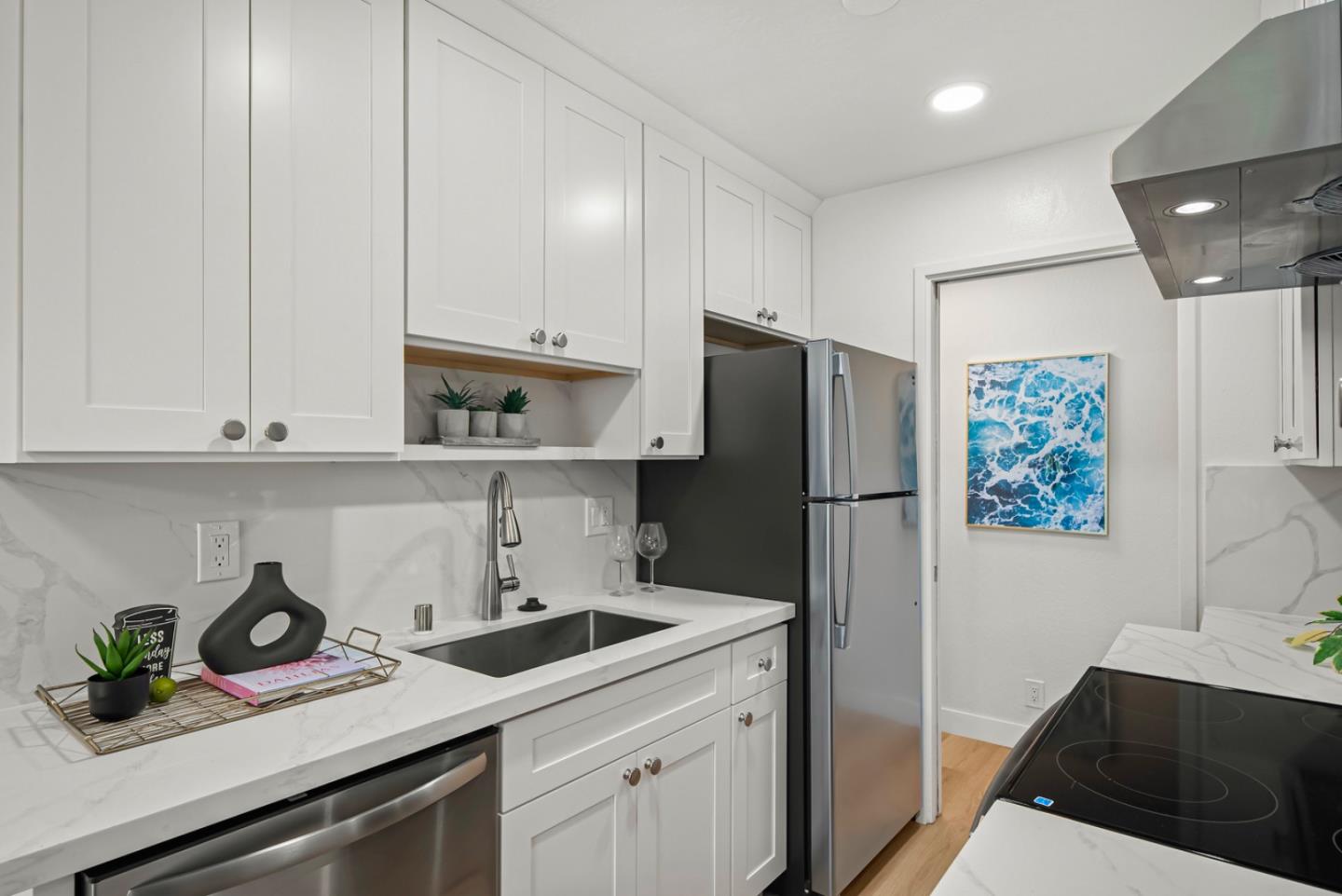280 Easy Street, Unit 311 Mountain View, CA 94043 - Photo 10 of 29 a kitchen with stainless steel appliances a sink cabinets and a counter top space