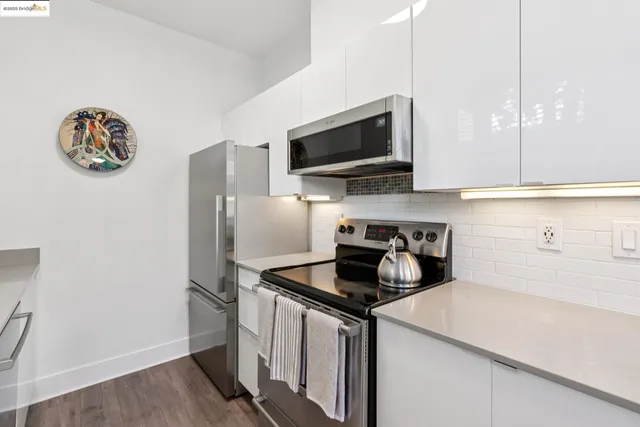 a view of a hallway with wooden floor and a living room
