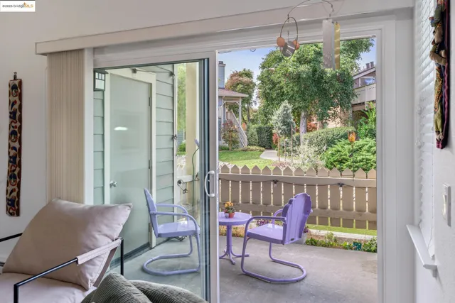 a balcony with table and chairs with wooden floor