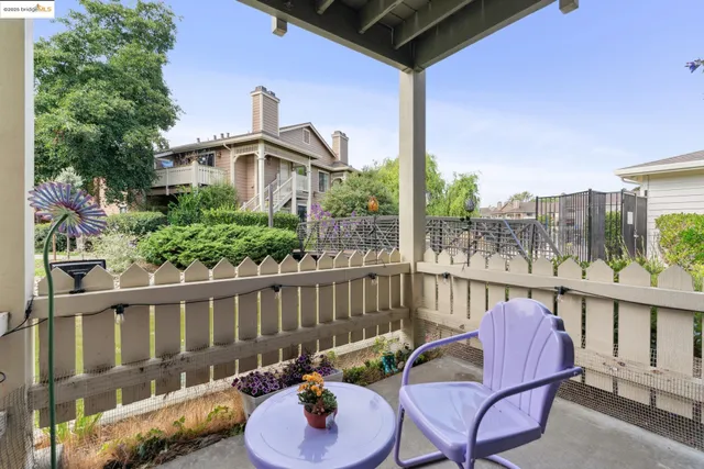 a view of a patio with a table and chairs