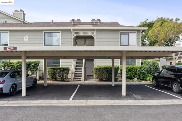 a view of a house with a small yard and plants