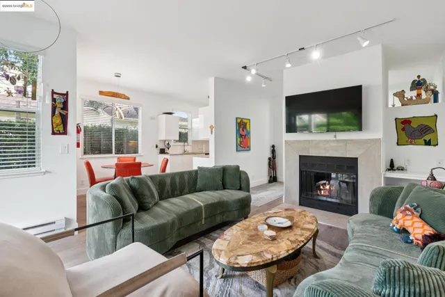 a living room with furniture a flat screen tv and a fireplace