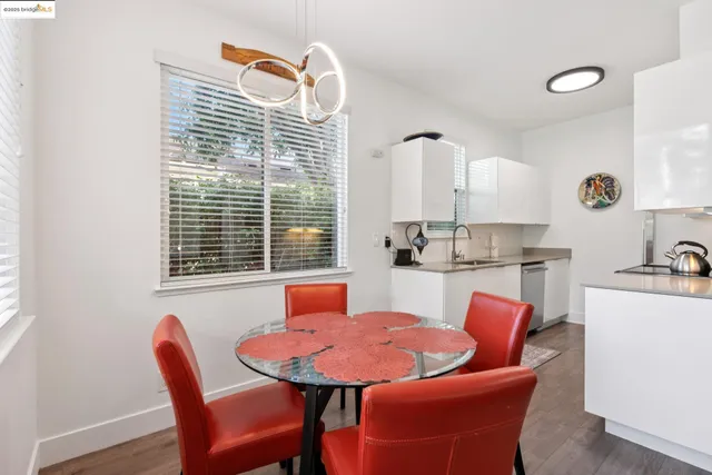 a kitchen with a table chairs and a sink
