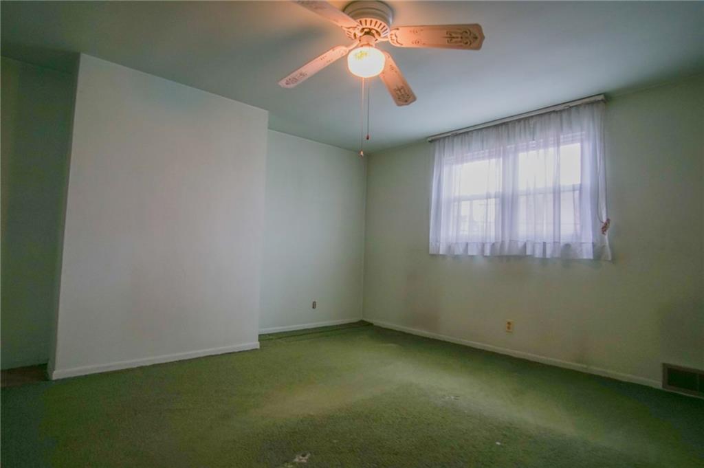 908 2nd Street McKees Rocks, PA 15136 - Photo 11 of 13 an empty room with a window and a fan