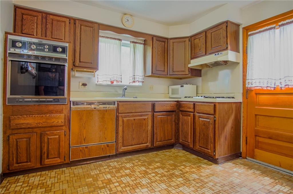 908 2nd Street McKees Rocks, PA 15136 - Photo 4 of 13 a kitchen with stainless steel appliances granite countertop a refrigerator and a stove top oven