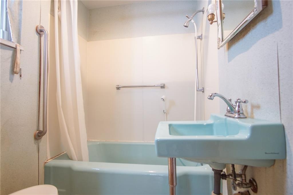 908 2nd Street McKees Rocks, PA 15136 - Photo 5 of 13 a bathroom with a sink and a mirror