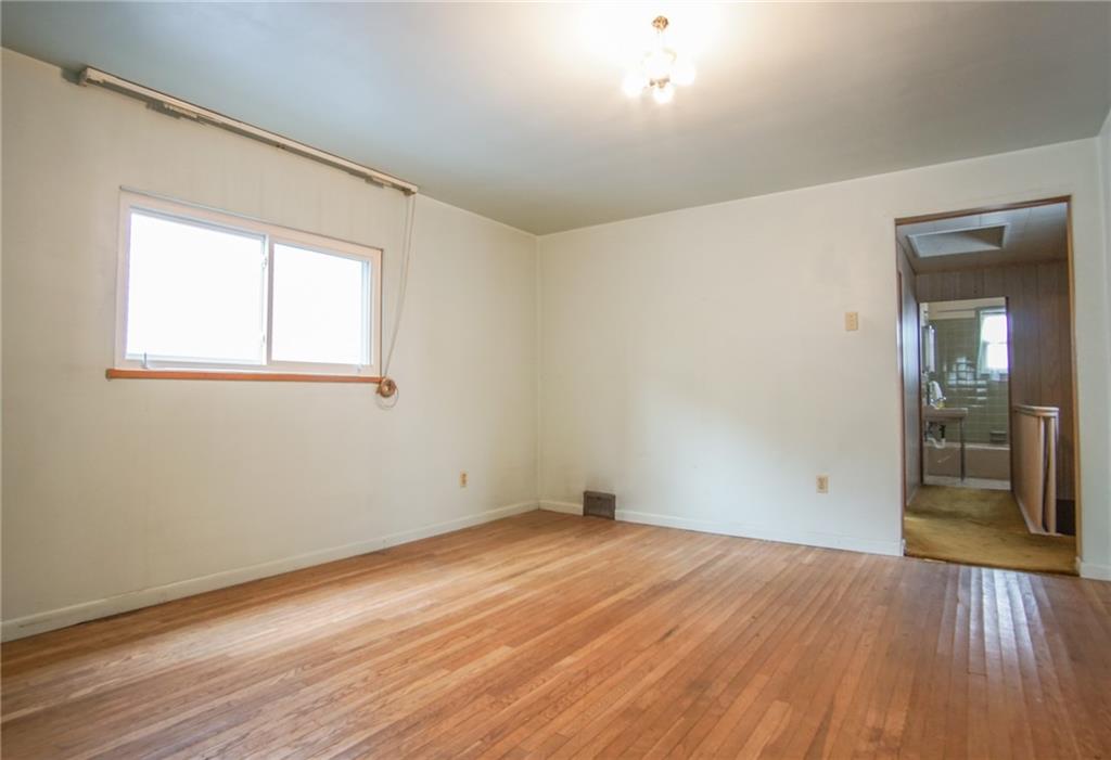 908 2nd Street McKees Rocks, PA 15136 - Photo 8 of 13 an empty room with wooden floor and windows