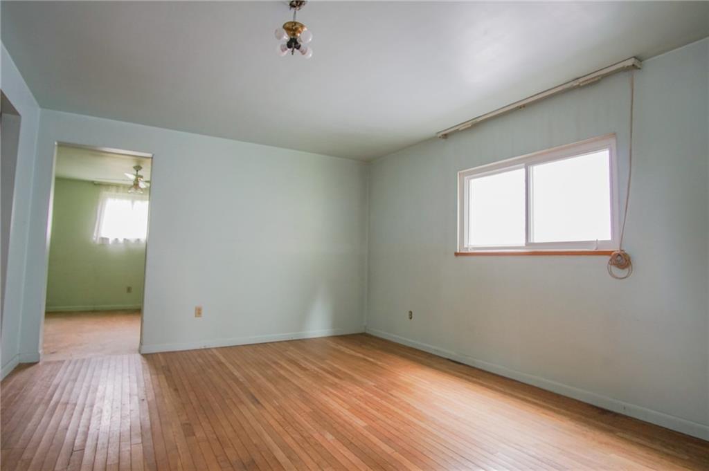 908 2nd Street McKees Rocks, PA 15136 - Photo 9 of 13 an empty room with wooden floor and windows