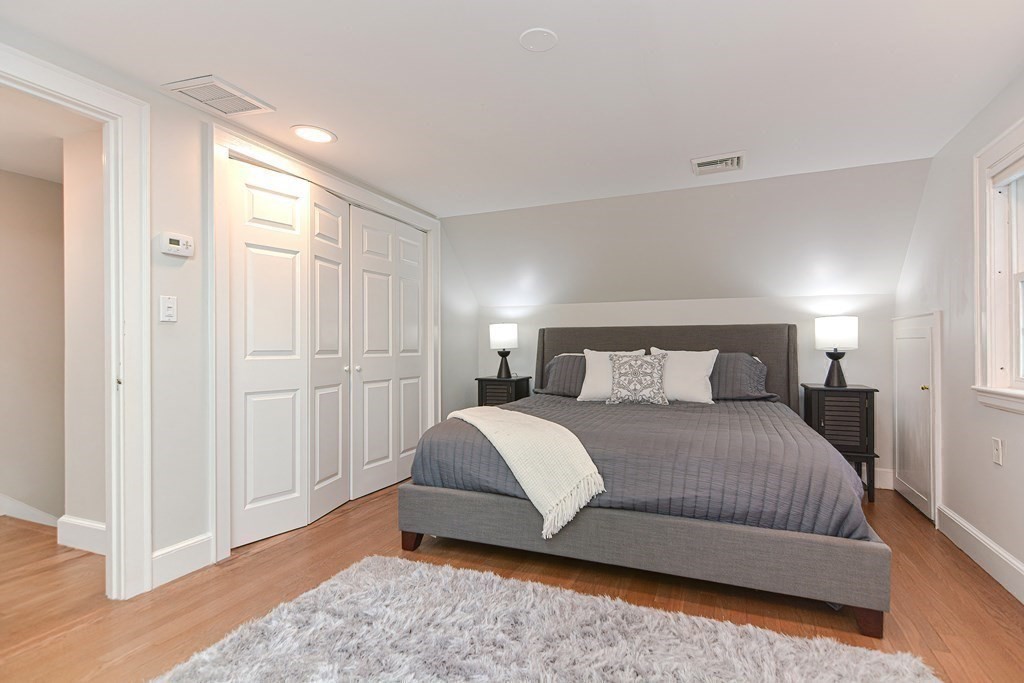 2 Shirley Road Wellesley, MA 02482 - Photo 21 of 32 a bedroom with a bed and wooden floor