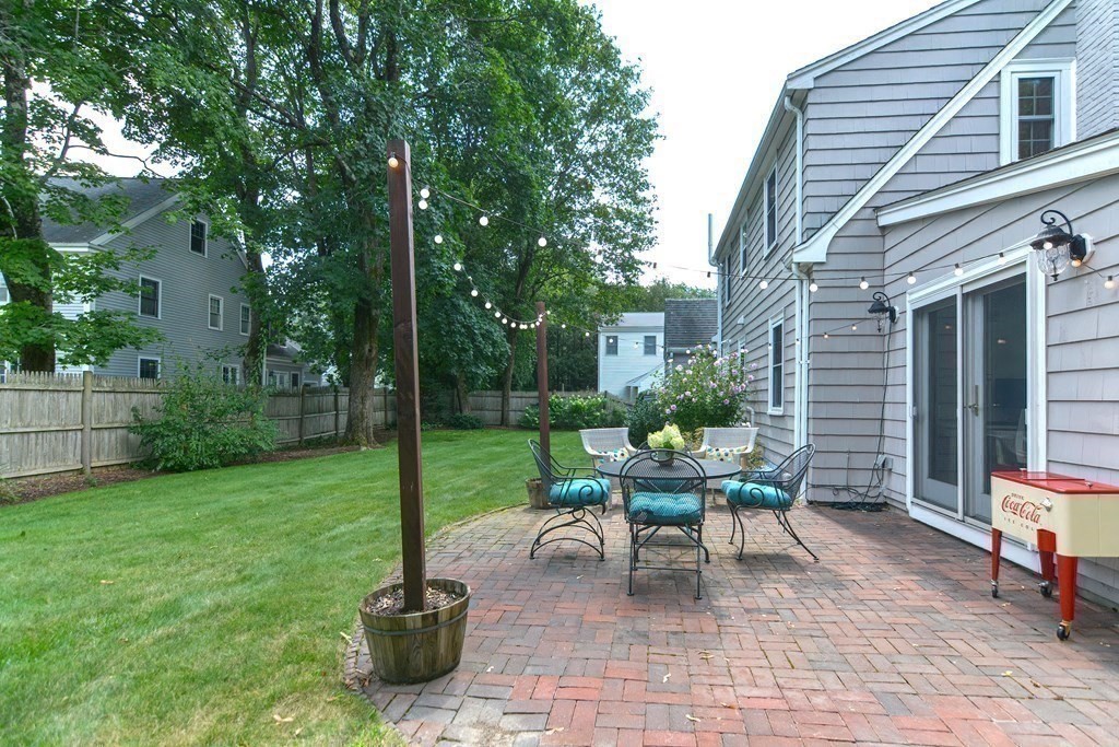 2 Shirley Road Wellesley, MA 02482 - Photo 30 of 32 a view of a patio with table and chairs potted plants and a large tree