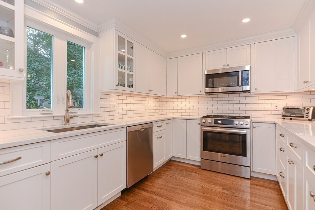 2 Shirley Road Wellesley, MA 02482 - Photo 8 of 32 a kitchen with cabinets stainless steel appliances a sink and a window