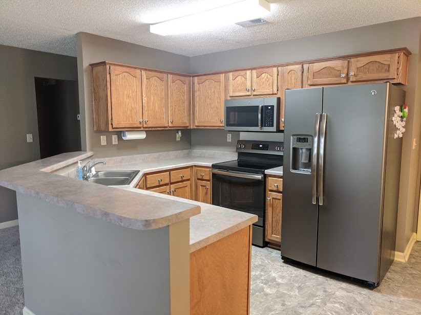 6862 Finch Road Memphis, TN 38141 - Photo 6 of 20 a kitchen with a refrigerator sink and microwave