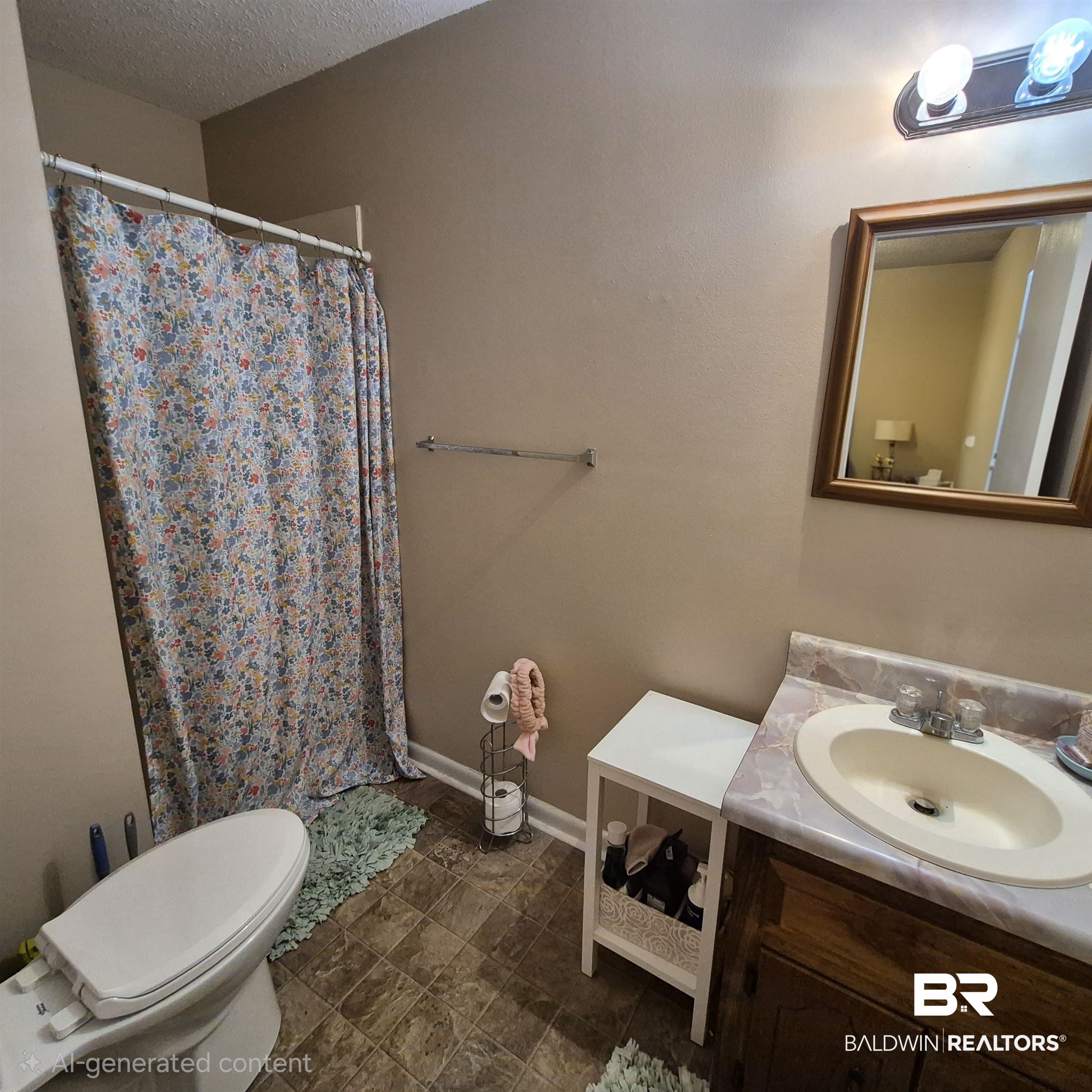 721 Perryman Street Evergreen, AL 36401 - Photo 13 of 26 Bathroom featuring a stall shower, vanity, and a textured ceiling