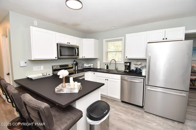 a dining room with furniture and wooden floor