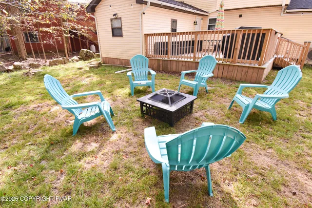 a view of a chairs and table in backyard