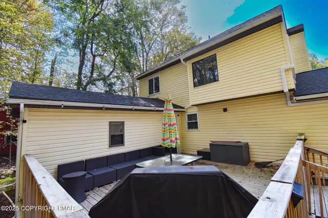 a view of house with backyard and seating