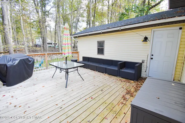 a view of a terrace with furniture and a yard