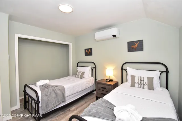 a bedroom with a bed and a flat screen tv