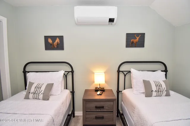 a bedroom with double bed and a lamp