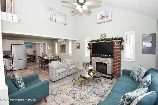 a living room with furniture a fireplace and a flat screen tv