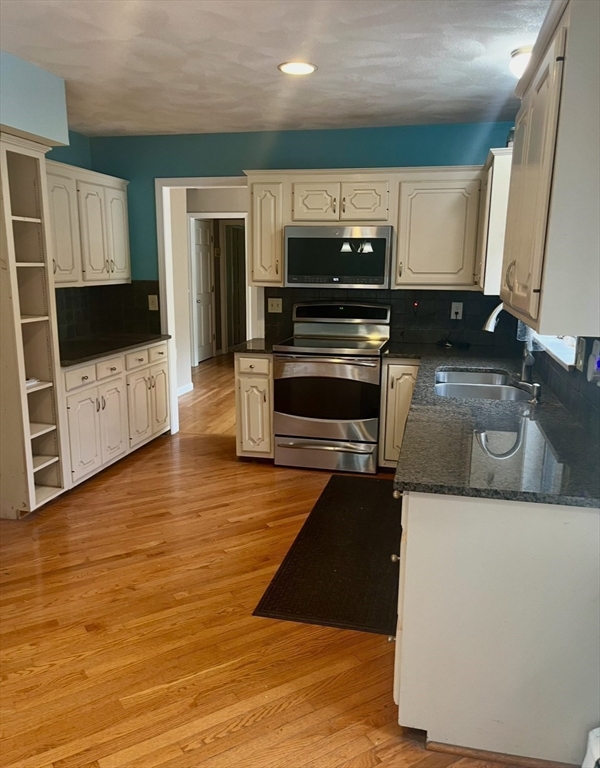 178 South Worcester Street Norton, MA 02766 - Photo 11 of 26 a kitchen with stainless steel appliances granite countertop a stove and a microwave