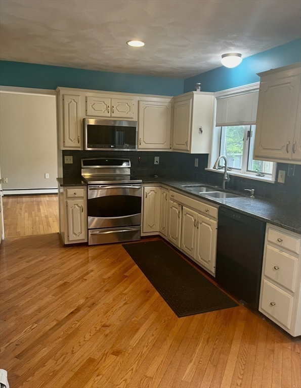178 South Worcester Street Norton, MA 02766 - Photo 12 of 26 a kitchen with stainless steel appliances a stove sink and microwave