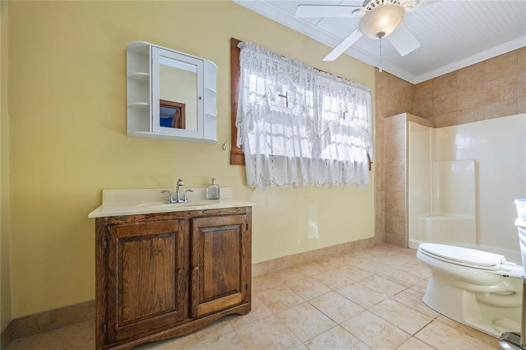 102 Mt Moriah Road Auburn, GA 30011 - Photo 13 of 44 a spacious bathroom with a granite countertop sink a toilet and a shower