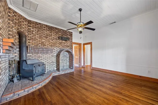 a view of livingroom with furniture chandelier fan and a fireplace