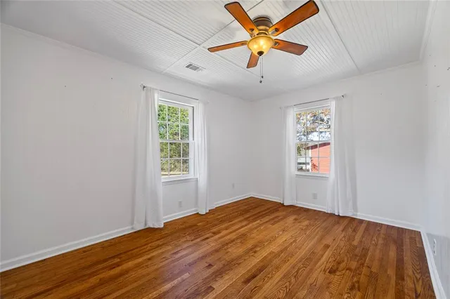 wooden floor in an empty room with a window