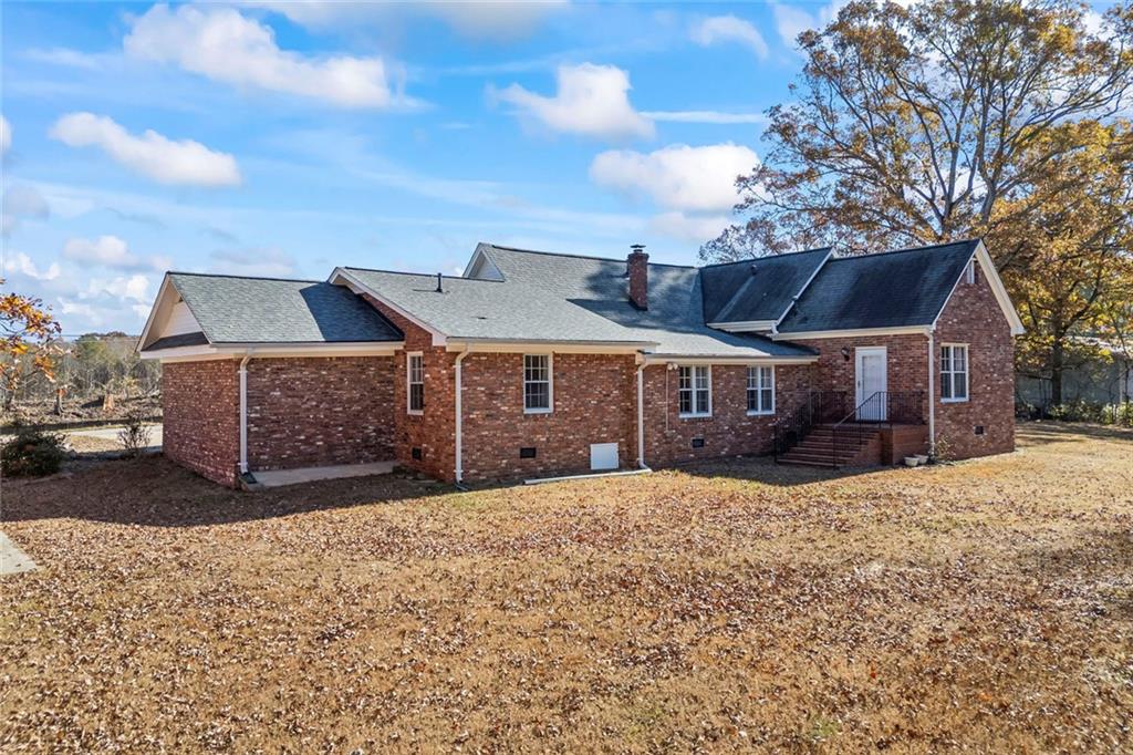 102 Mt Moriah Road Auburn, GA 30011 - Photo 26 of 44 a front view of a house with a yard covered with snow in front of house