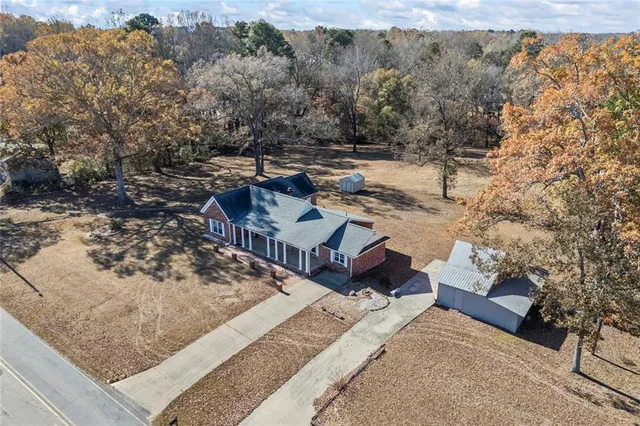 a view of a backyard with wooden fence