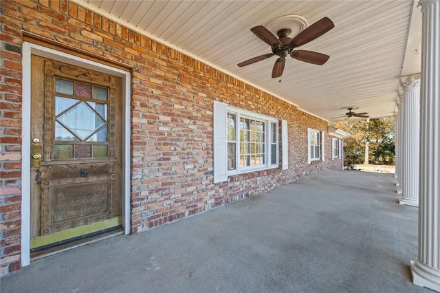 a view of a livingroom with a ceiling fan and window