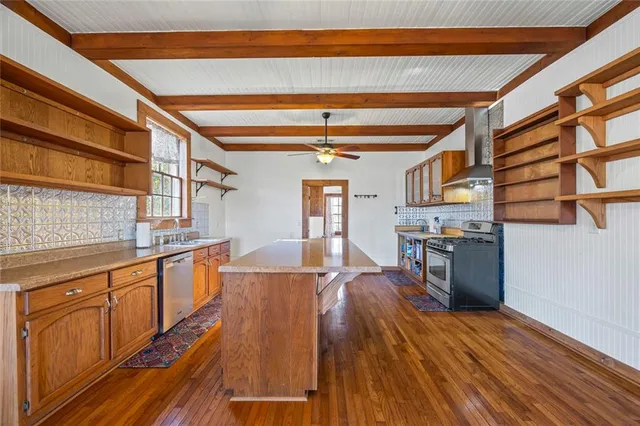 a view of a kitchen with furniture and wooden floor