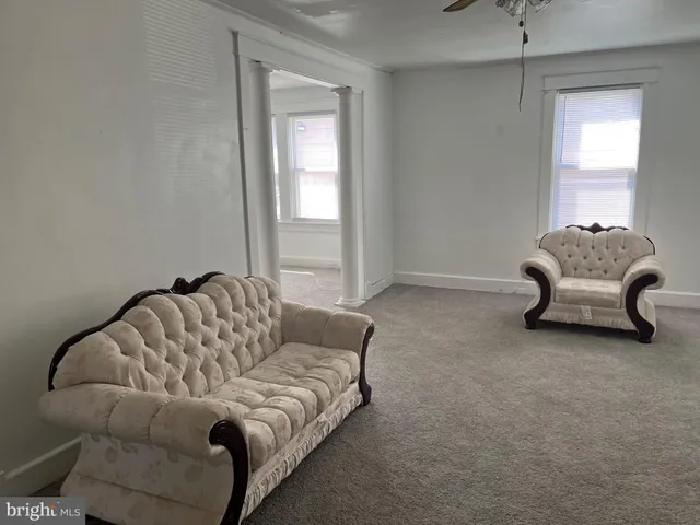 a bathroom with a toilet a sink and a window