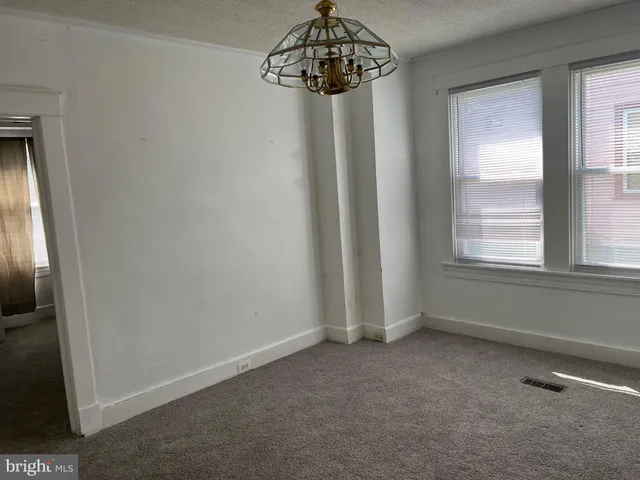 a kitchen with granite countertop white cabinets and a sink