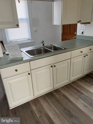 a view of a room with wooden floor