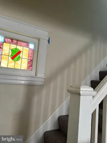 a view of a room with wooden floor and windows