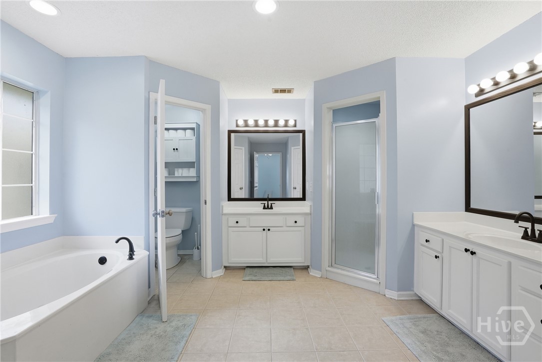 17 Mallorys Way Savannah, GA 31419 - Photo 26 of 41 Primary bathroom with double vanities and white cabinets