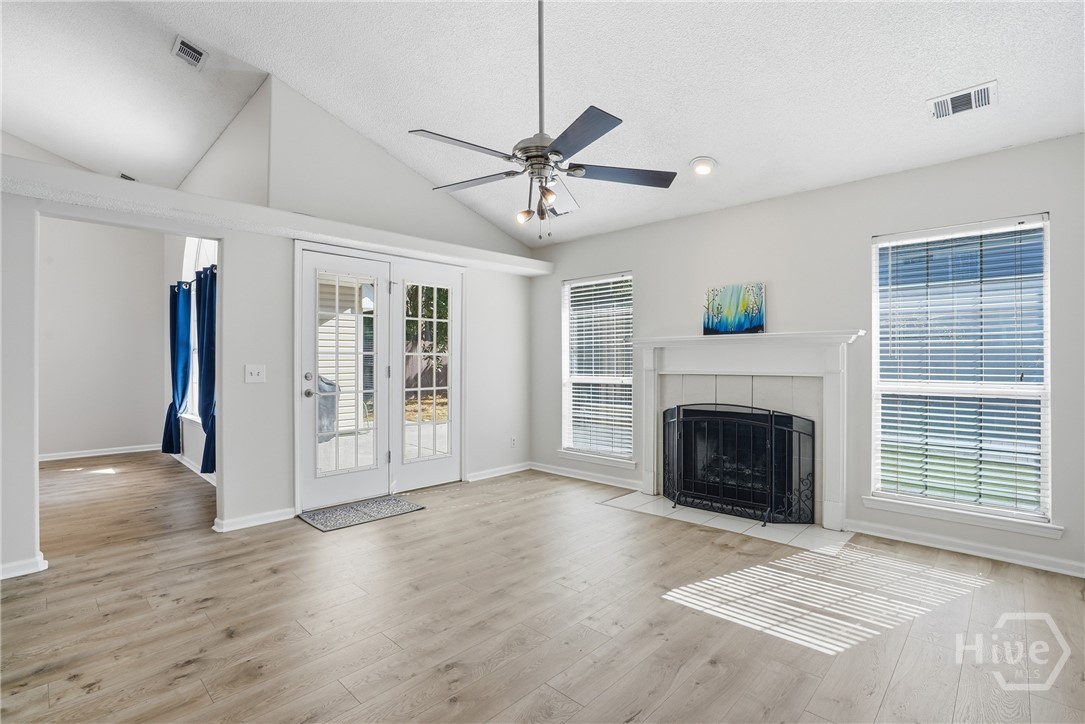 17 Mallorys Way Savannah, GA 31419 - Photo 3 of 41 Living room with fireplace and wood-like floors and vaulted ceiling