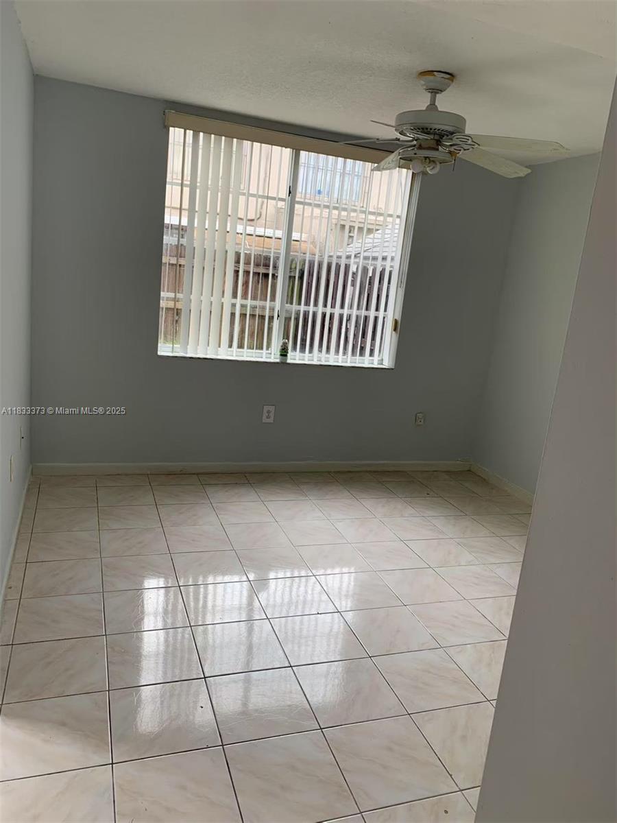 1062 West 42nd Place, Unit STUDIO Hialeah, FL 33012 - Photo 4 of 8 a view of an empty room with a window