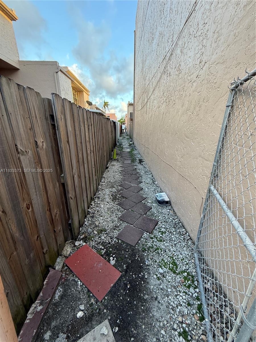 1062 West 42nd Place, Unit STUDIO Hialeah, FL 33012 - Photo 7 of 8 a view of a backyard with wooden fence