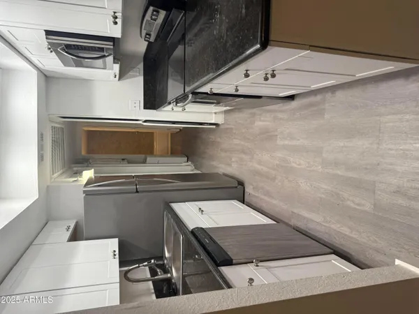 a view of kitchen stove top oven and cabinets