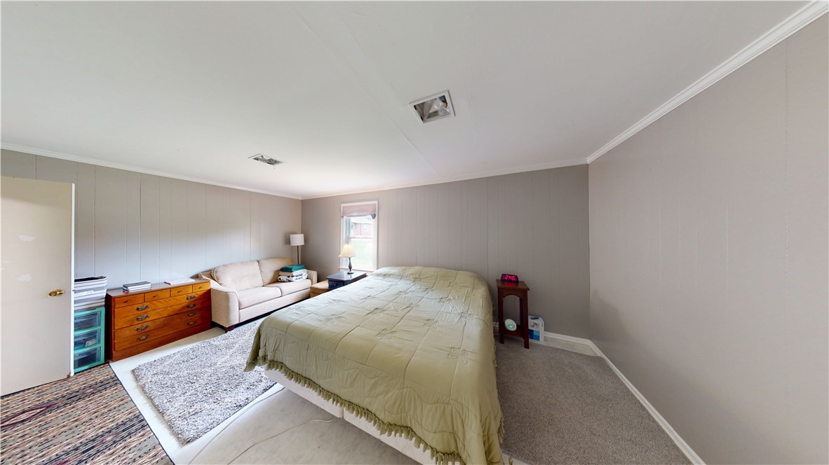 415 Church Street Pendleton, SC 29670 - Photo 25 of 35 Comfortable bedroom with carpet and paneling offers a peaceful retreat.