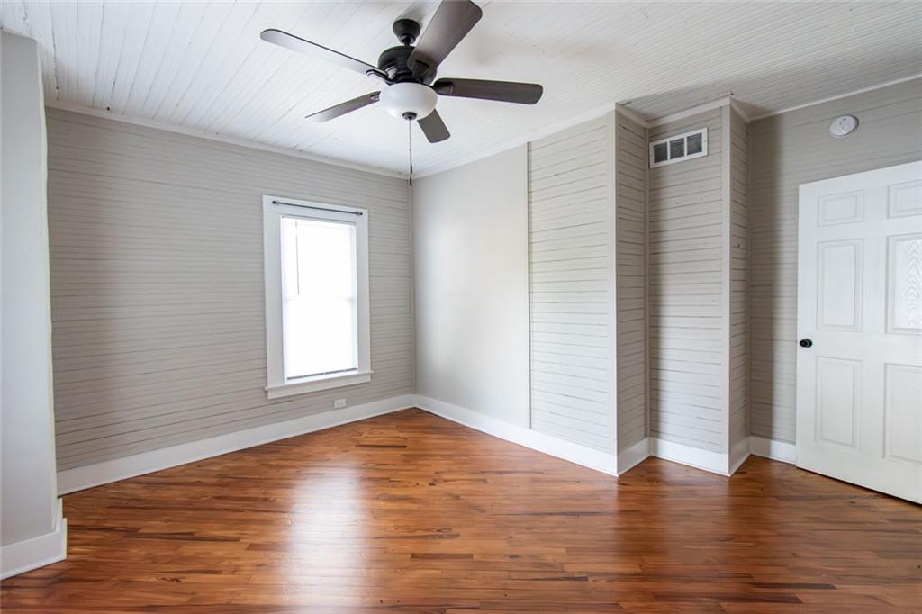 702 Radford Street Monroe, GA 30655 - Photo 39 of 49 an empty room with wooden floor and windows