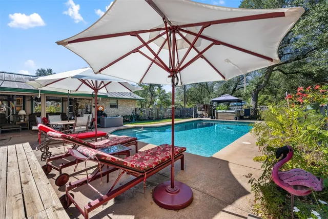 a backyard of a house with barbeque oven table and chairs